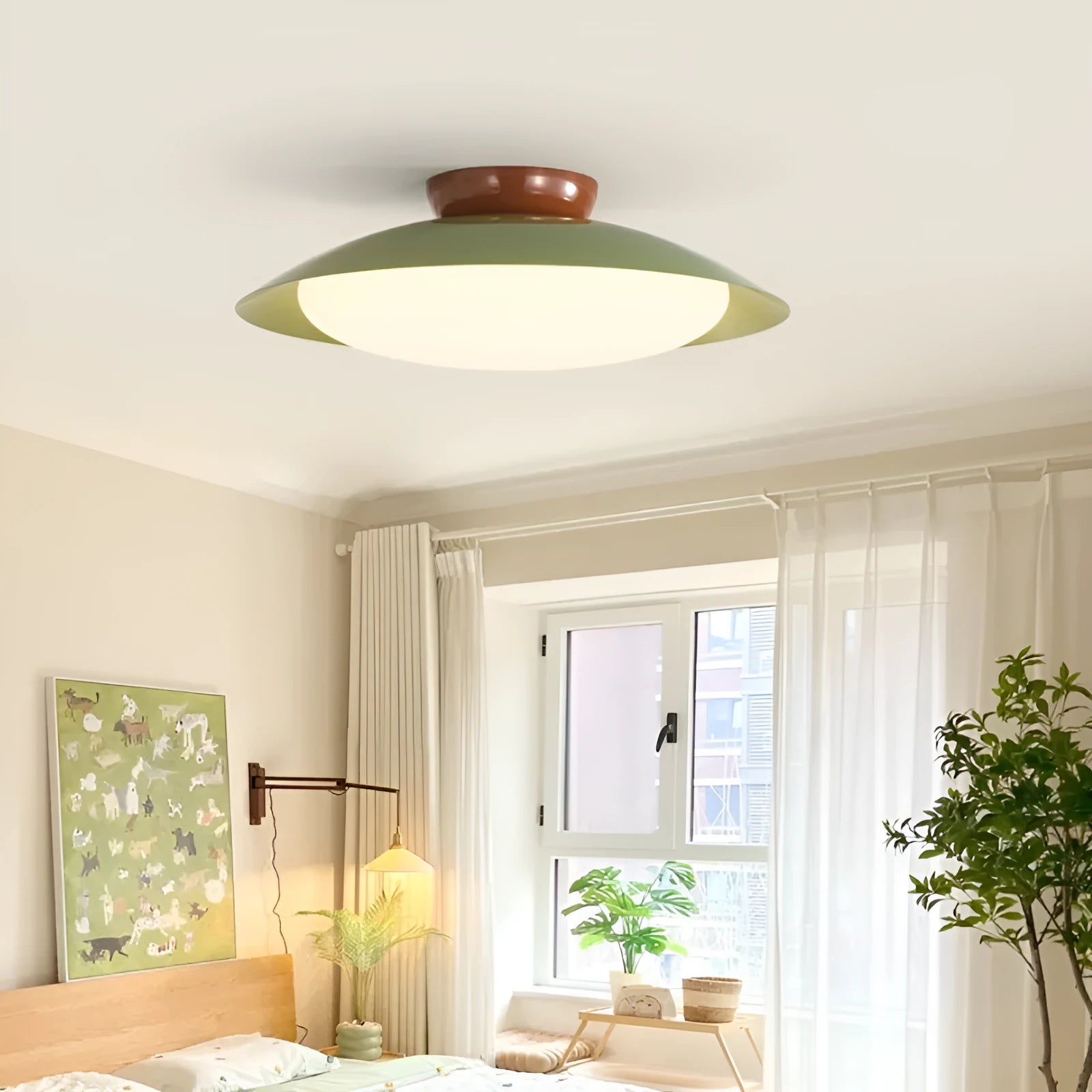 Modern minimalist flying saucer design ceiling lamp in cream yellow on a white ceiling.