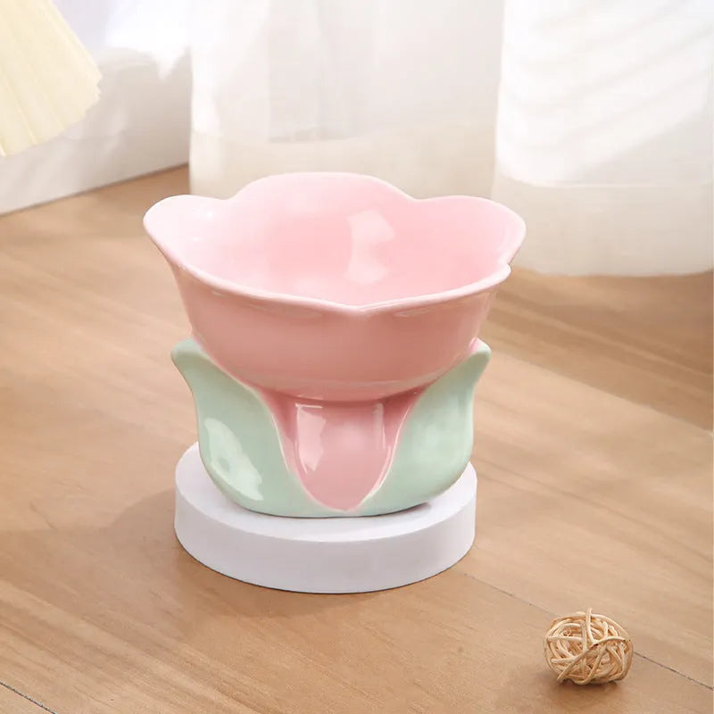 Blue floral patterned raised ceramic pet bowl for cats and dogs on a non-slip base.