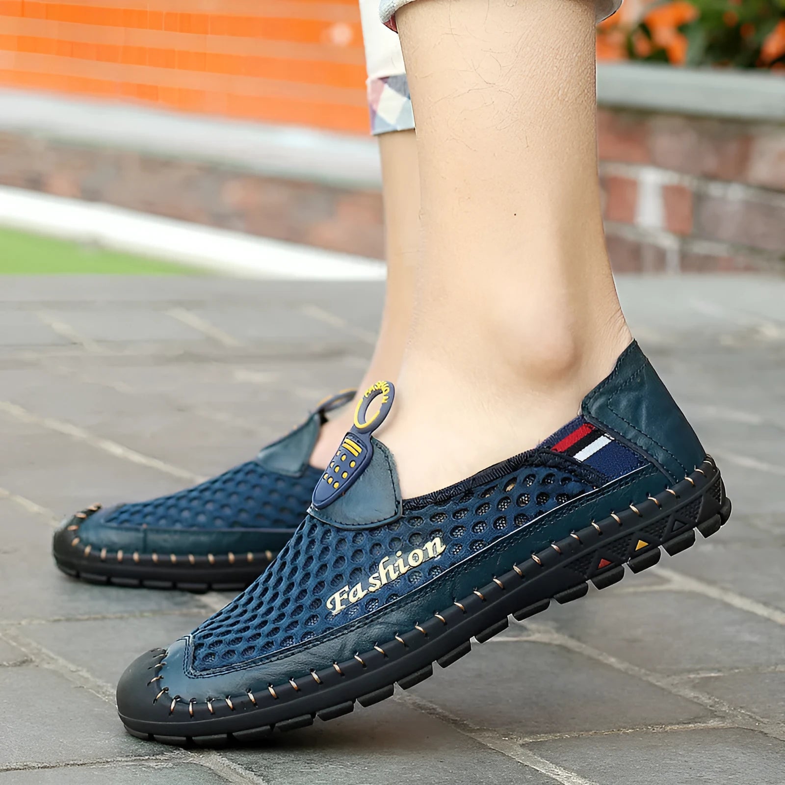 Men's brown casual shoes with mesh upper and rubber sole, showing round toe and stitching detail