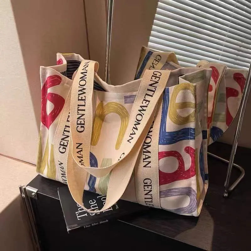 Canvas women's tote bag with printed letter or pattern designs and shoulder straps
