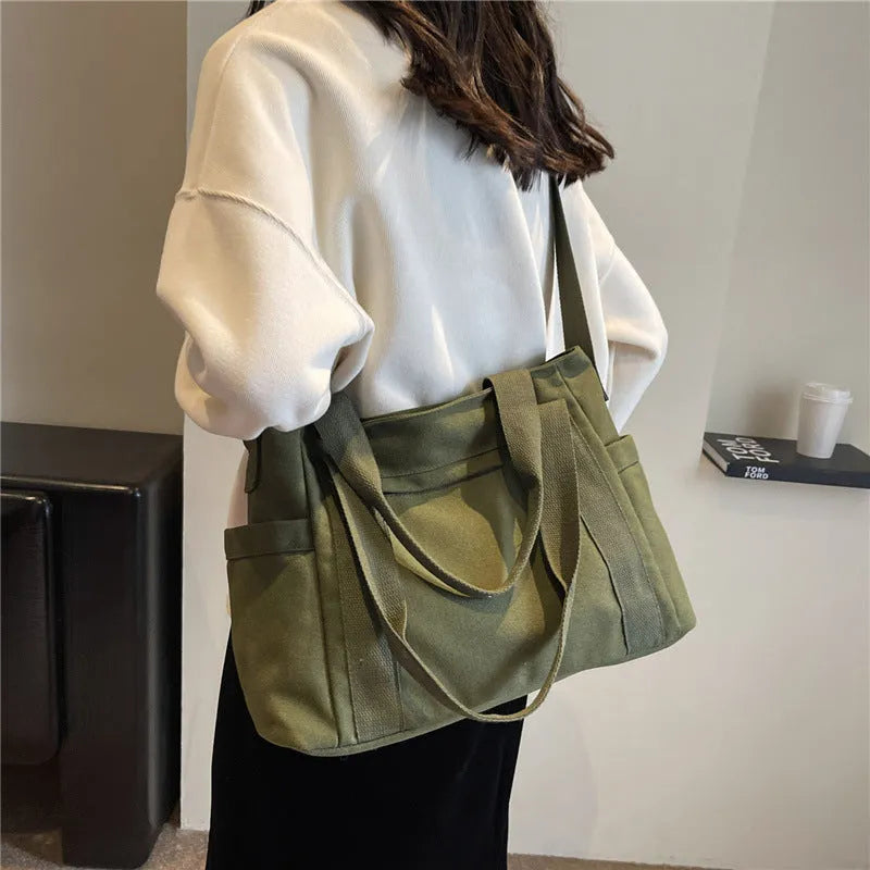Women's canvas-style polyester shoulder bag with sandwich pocket and phone compartment in solid colour
