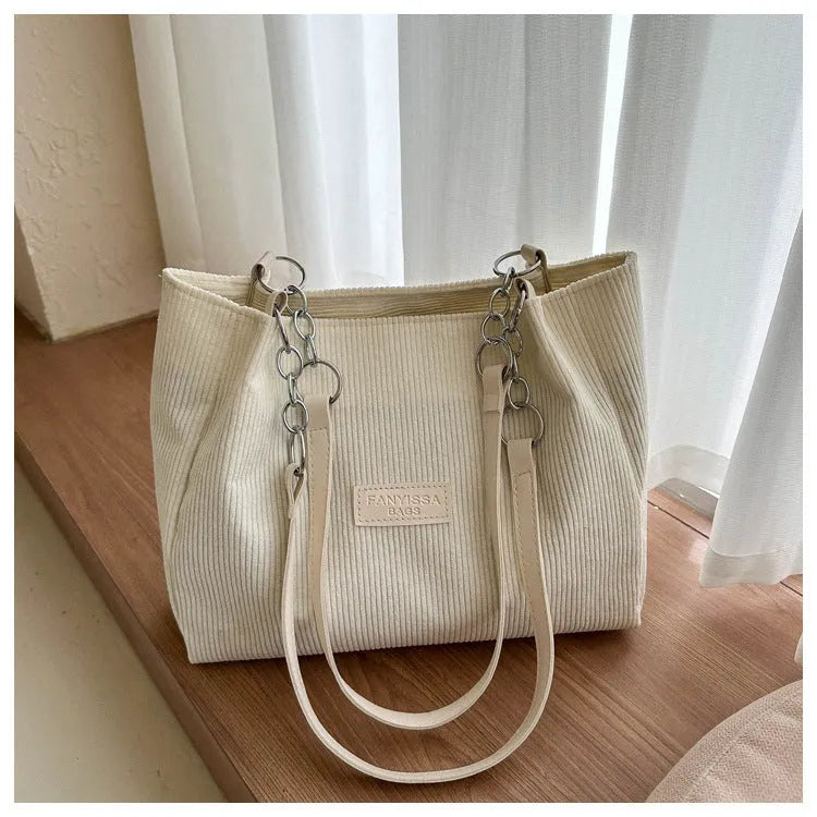 Corduroy one-shoulder tote handbag in a horizontal square shape, shown in brown colour.