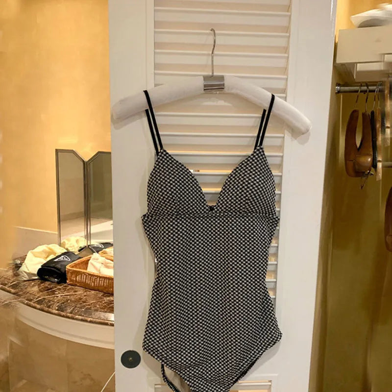 Blue one-piece swimsuit for women offering belly coverage and modest fit for hot spring use.