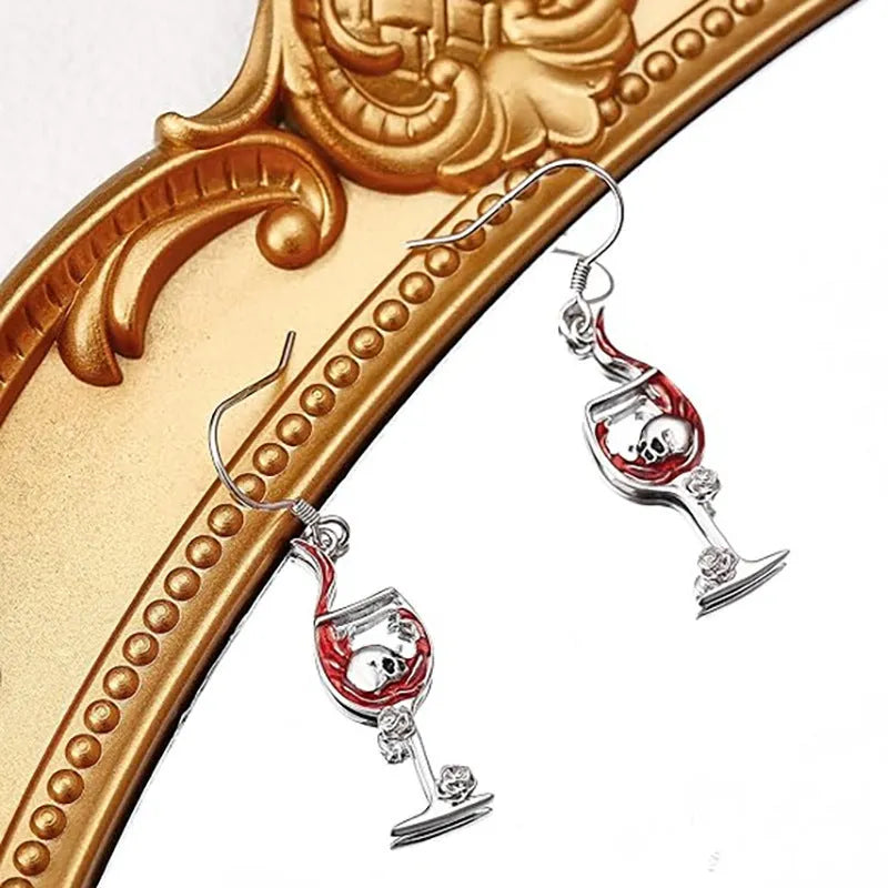 A pair of metallic geometric skull wine glass earrings for women, shown in dark gothic style.