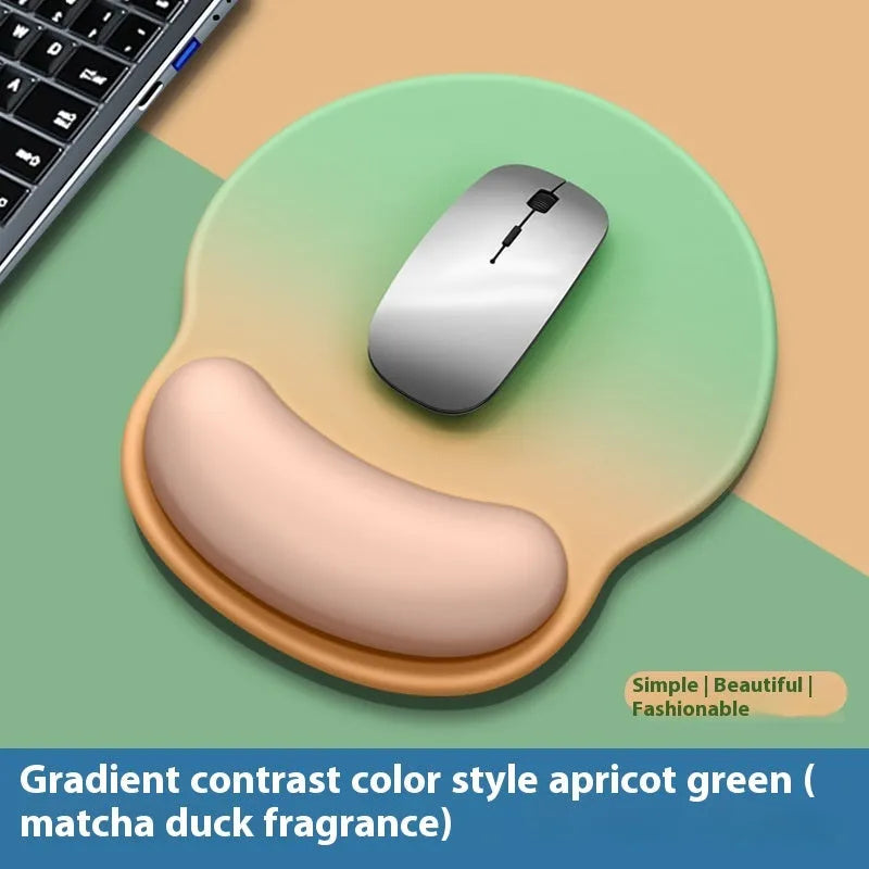 Silicone mouse mat with attached gel wrist support in a gradient blue colour on a desk.