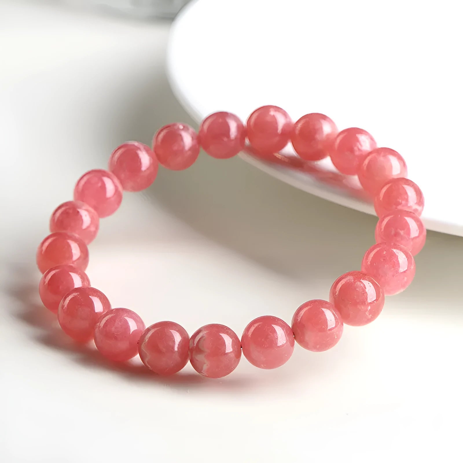 Women's geometric crystal bracelet with natural red patterned stone beads and longevity lock design element