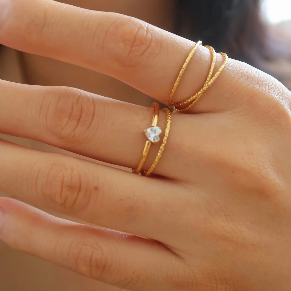 Golden electroplated stainless steel love heart ring showing heart shape design elements
