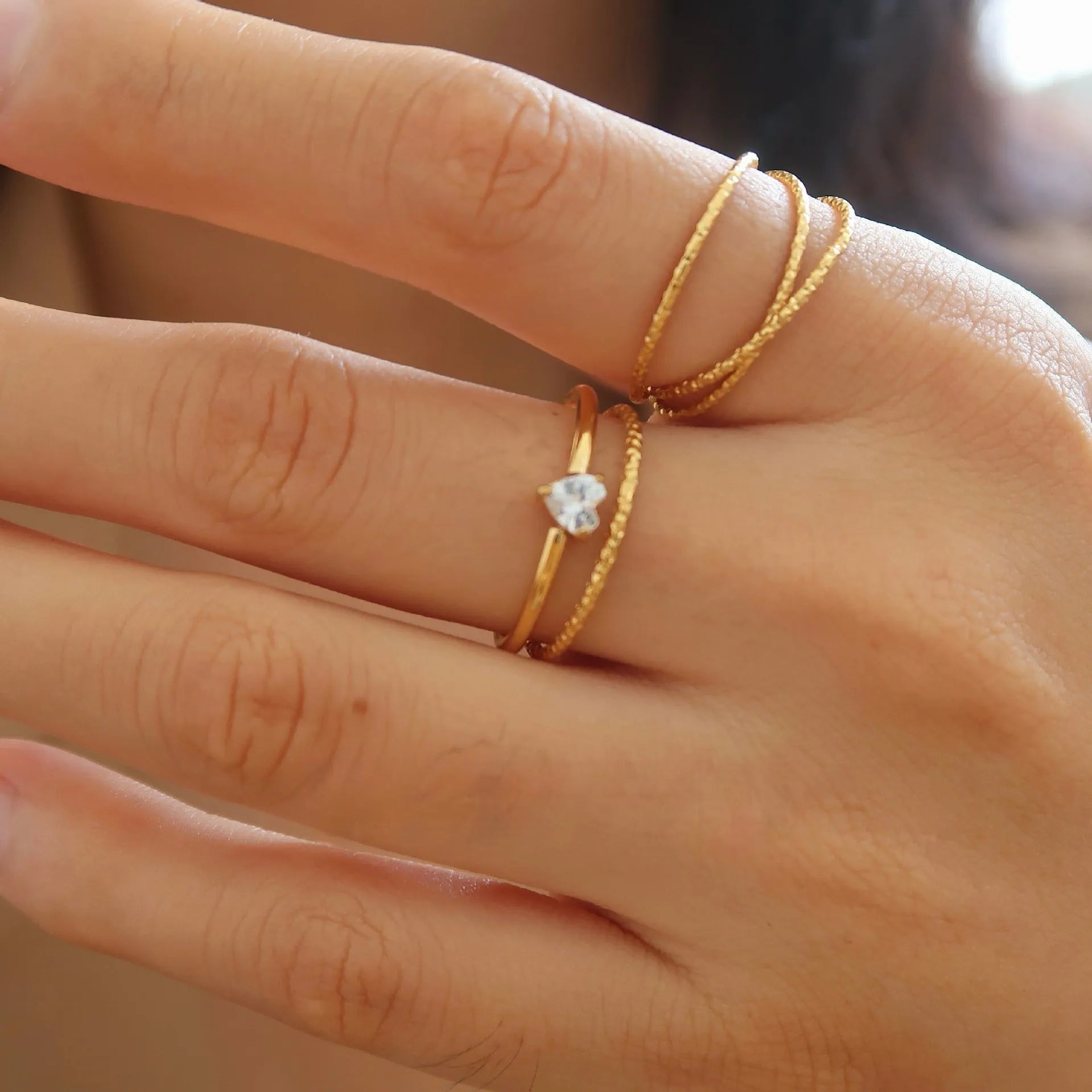 Golden electroplated stainless steel love heart ring showing heart shape design elements