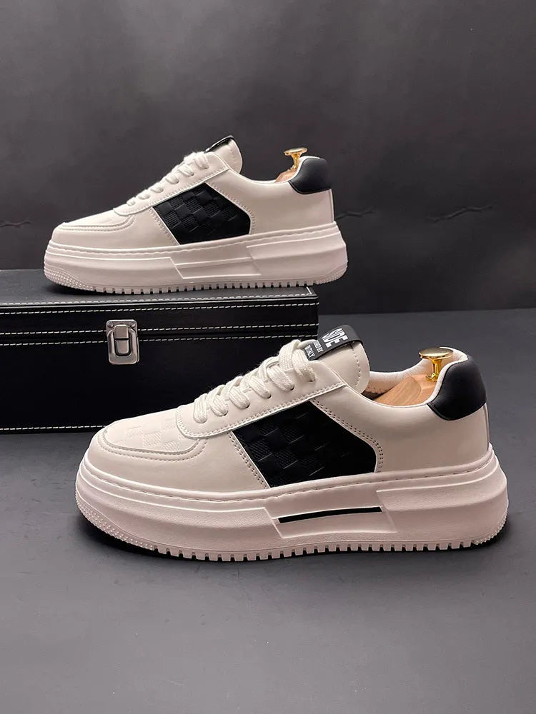 White and green sports casual shoes with cloth upper and rubber foam sole on a plain background.