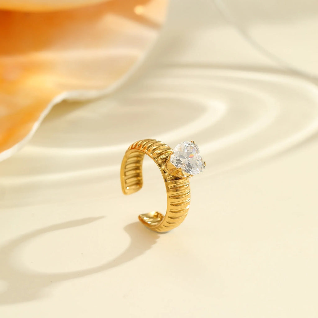 Women's geometric stainless steel ring with gold plating and inlaid zircon stones, shown in an open mouth free size design.