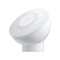 White Mijia Bluetooth bedside night light with human body induction on a wooden table.