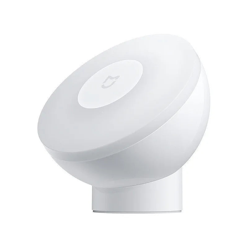 White Mijia Bluetooth bedside night light with human body induction on a wooden table.