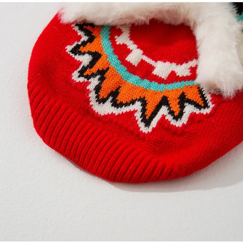 Red knitted lion dance pet sweater with 3D plush face details and colourful embroidery on a cat