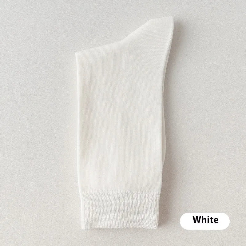Mid-calf men's socks in solid colours made from combed cotton, shown in a stack.