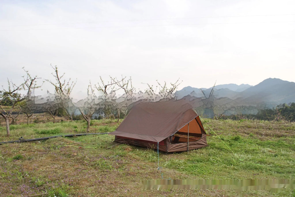 Brown A-line cabin tent pitched with hiking poles as structural support showing spacious interior for 2-3 people