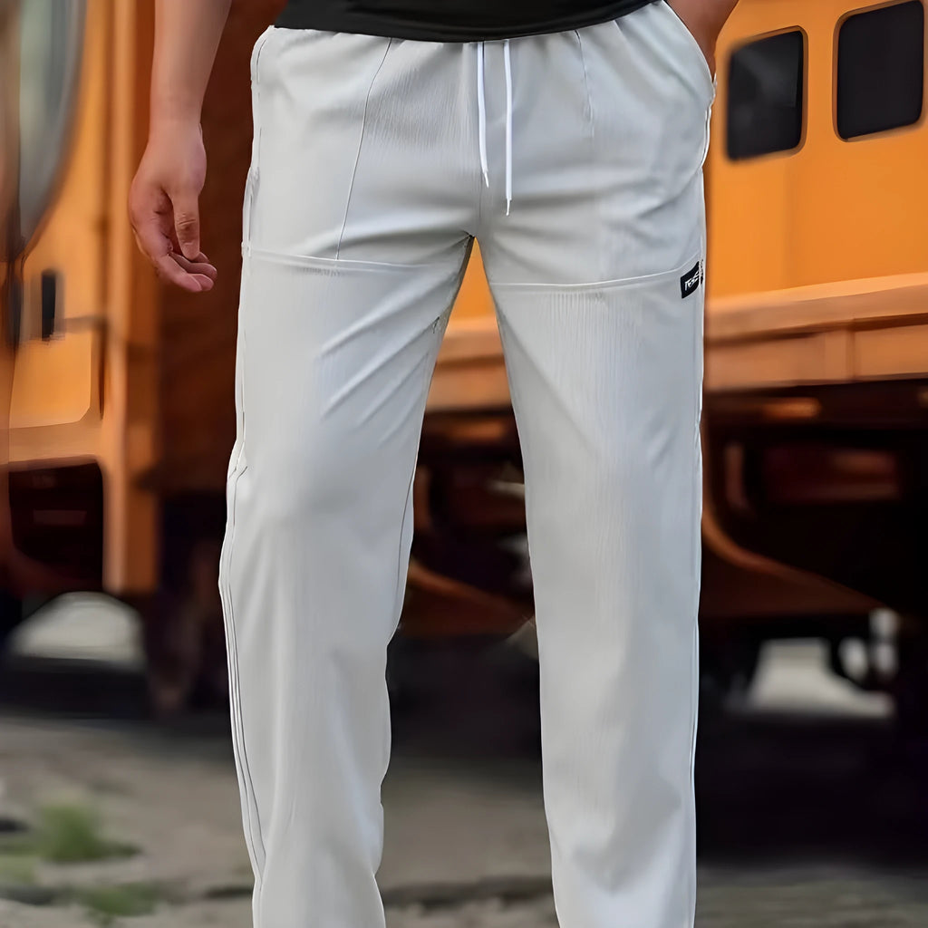 Men's lightweight polyester casual trousers in light grey colour shown flat