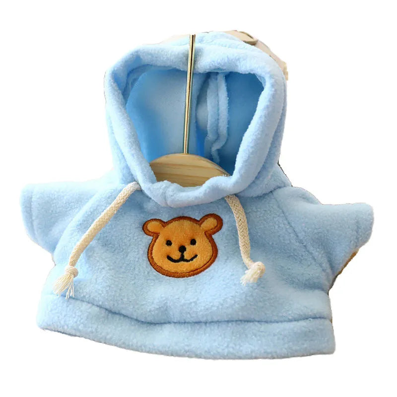Dog wearing a blue hooded balaclava sweater, showing the integrated hood design and cloth fabric.