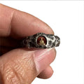 Copper Buddha ring with rock texture surface showing hand-forged details and Buddhist imagery