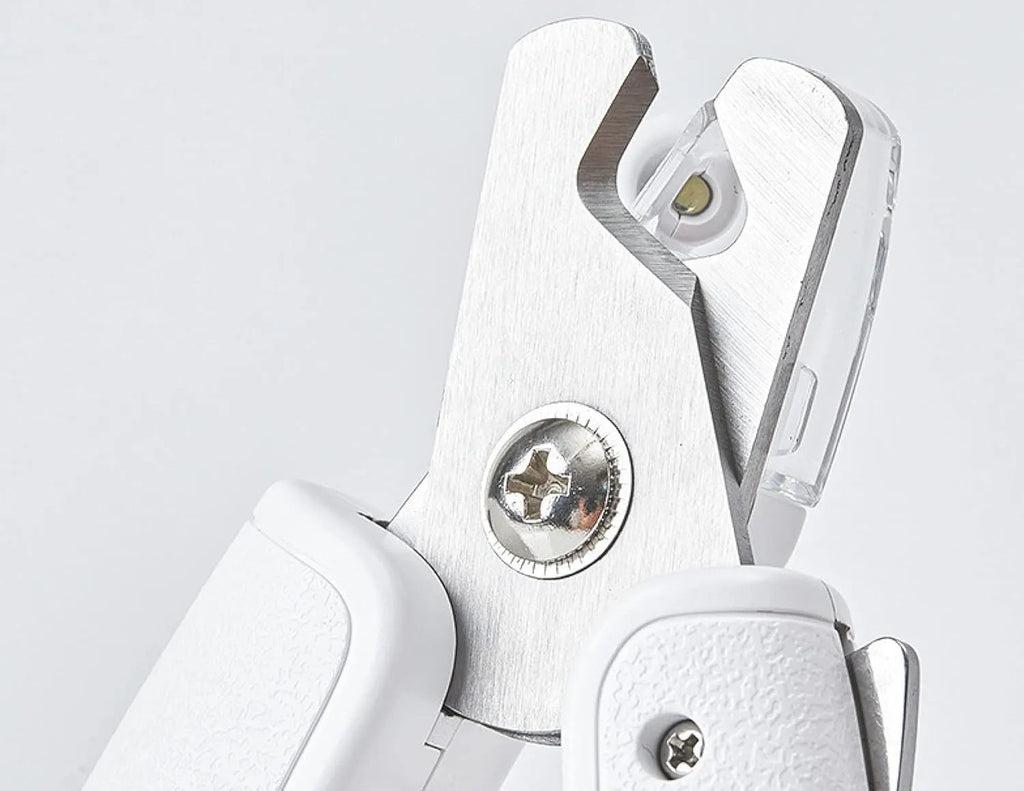 White LED pet nail clippers with open anti-splash guard and nail file on a solid colour background