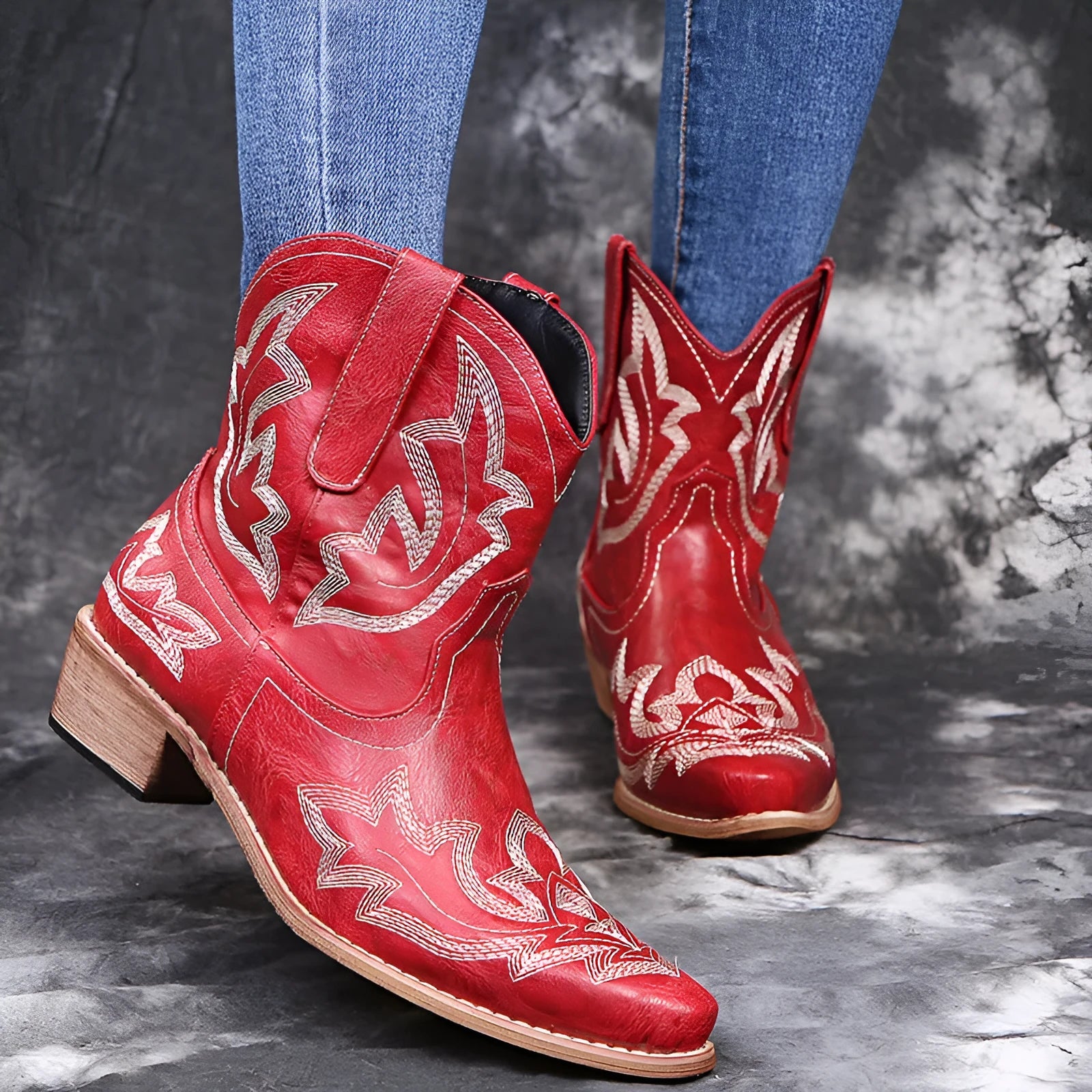 Women's blue embroidered Western cowgirl boots with a low wedge heel and pointed toe.