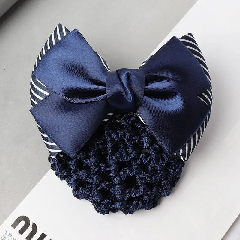 Professional flower bow headdress hair clip ornament on a work plate, shown in a selection of net and mesh colour variations.