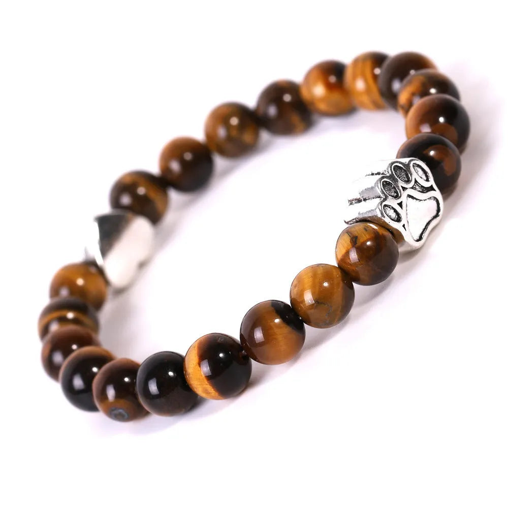 A round beaded stone bracelet in a Tiger Eye or Indian Agate style on a wrist.