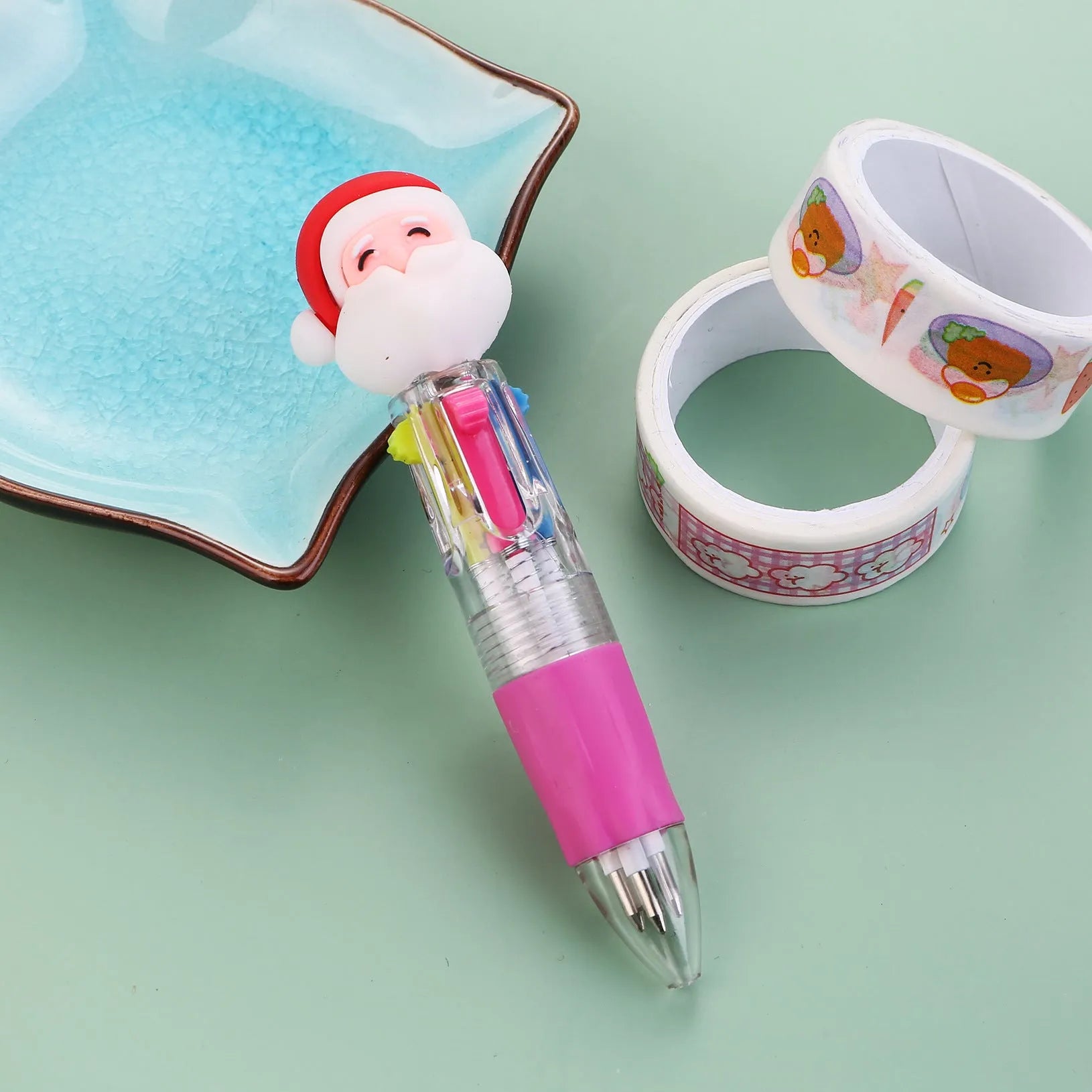 Compact 11cm Christmas four-colour press pen with festive designs including reindeer and snowmen.