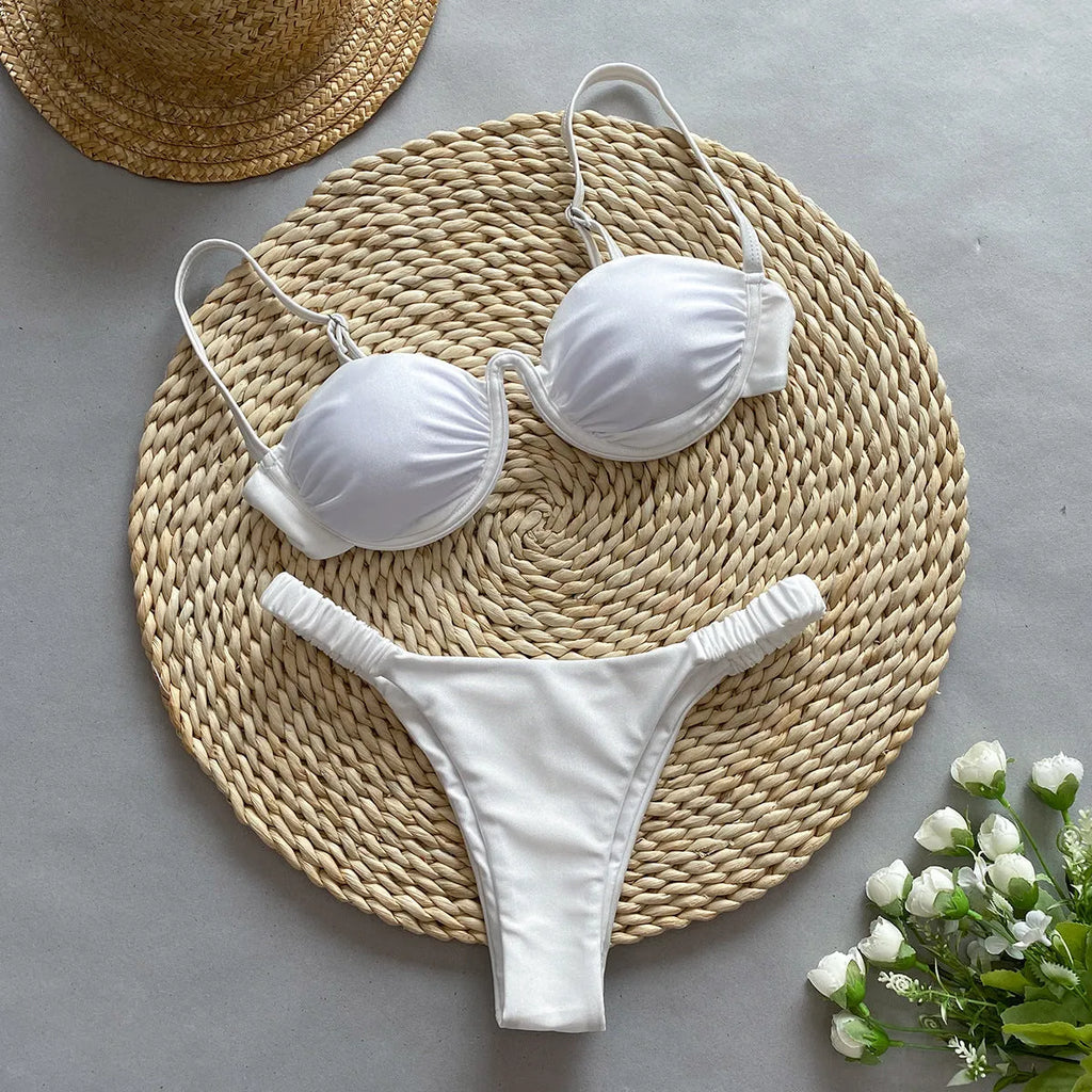 Women's black underwire bikini top and briefs set on a mannequin, showing sleeveless design.