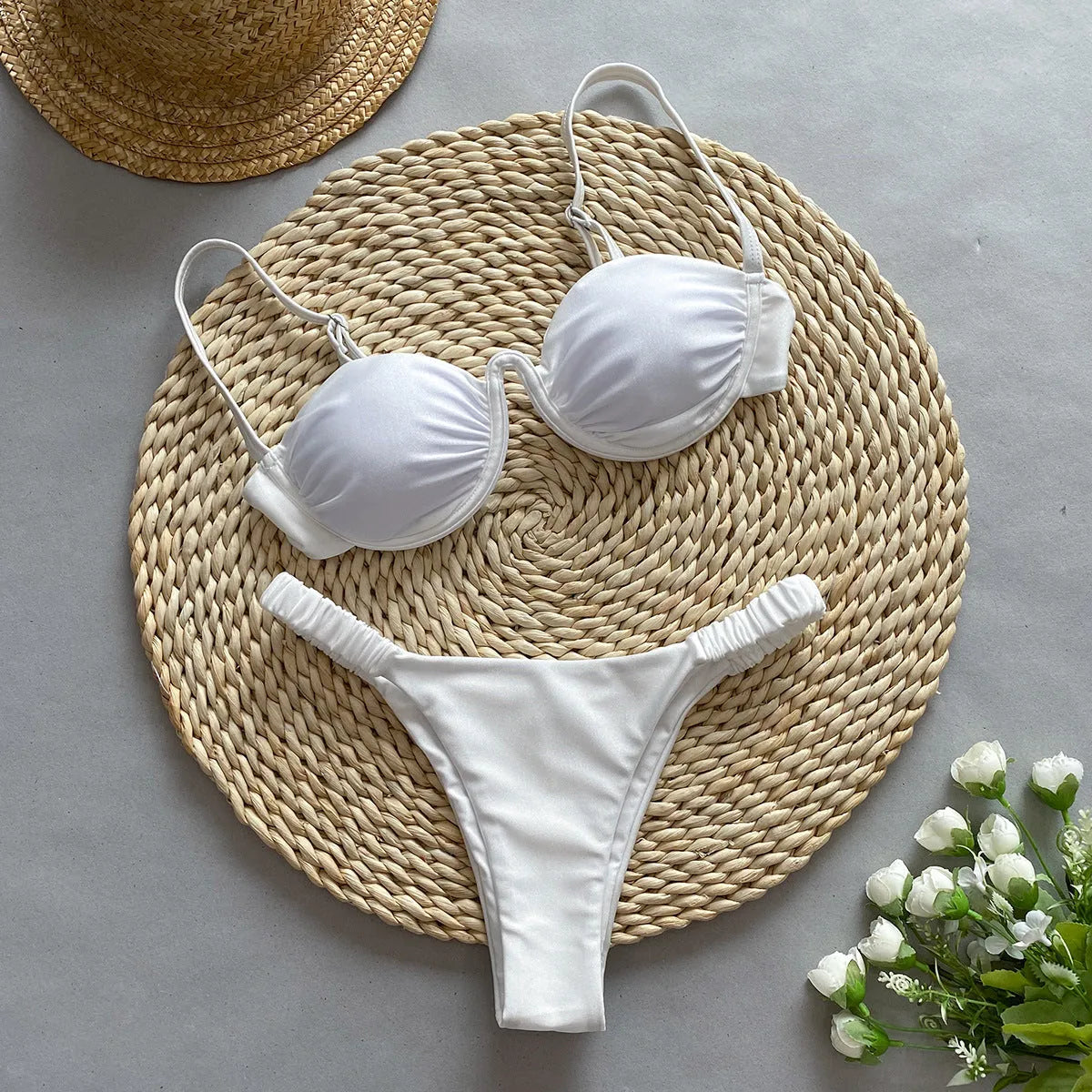 Women's black underwire bikini top and briefs set on a mannequin, showing sleeveless design.
