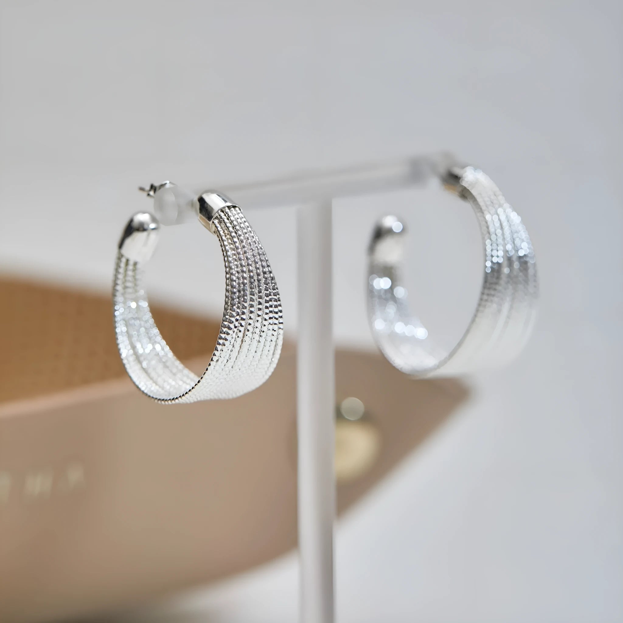 Geometric copper earrings with electroplated silver and gold finishes, including stud and clip-on options