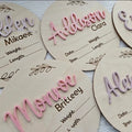 Square wooden baby name plaque showing newborn birth information, 15cm on each side.