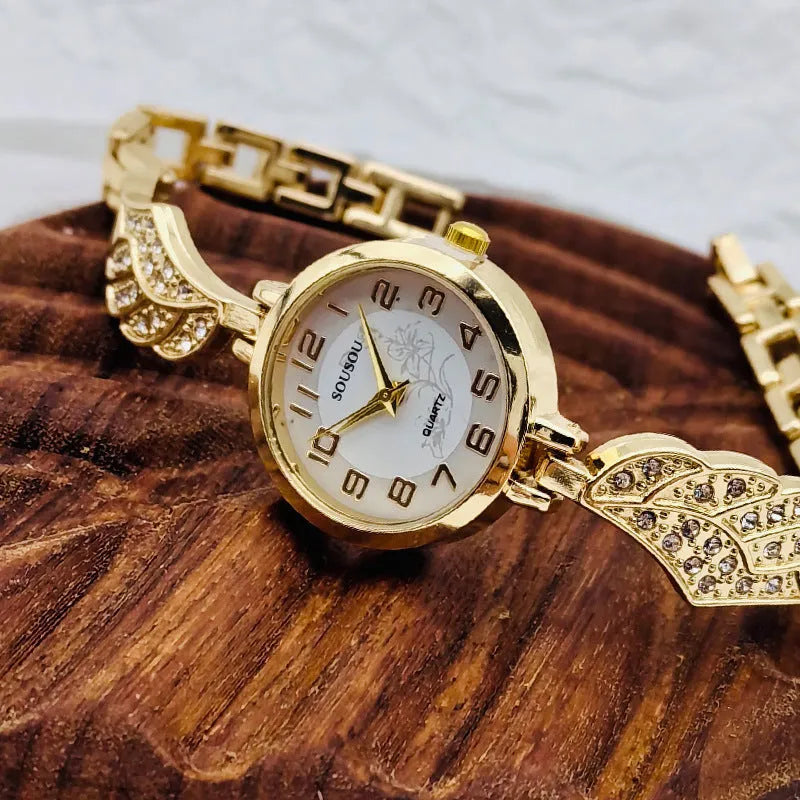 Stainless steel women's watch with round dial on wrist, showing gold surface finish option.