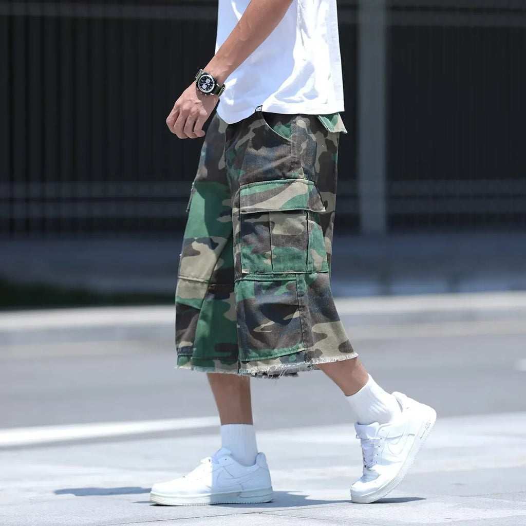 Men's loose-fit camouflage print shorts in retro workwear style on a white background.