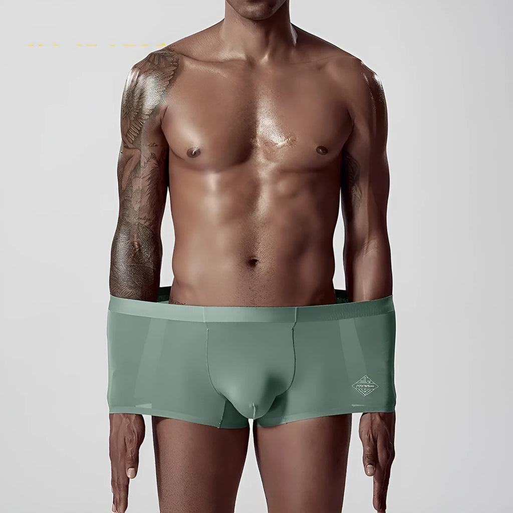 Men's seamless one-piece modal underwear in green, showing mid-waist fit and solid colour design.