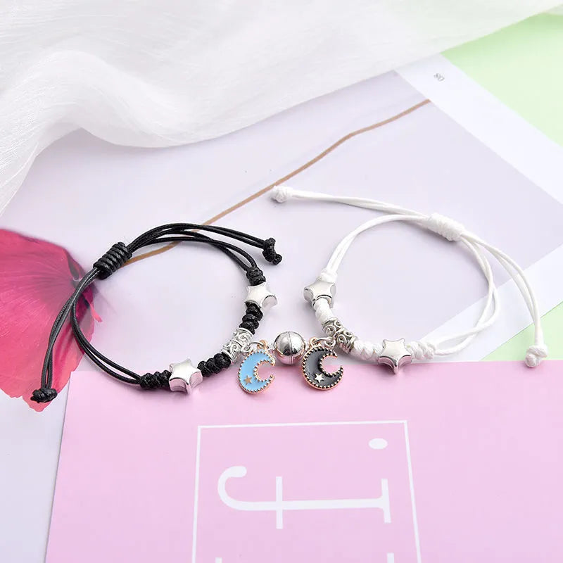 Pair of alloy suction bracelets with engraved symbol choices including crown, love lock, and clover.