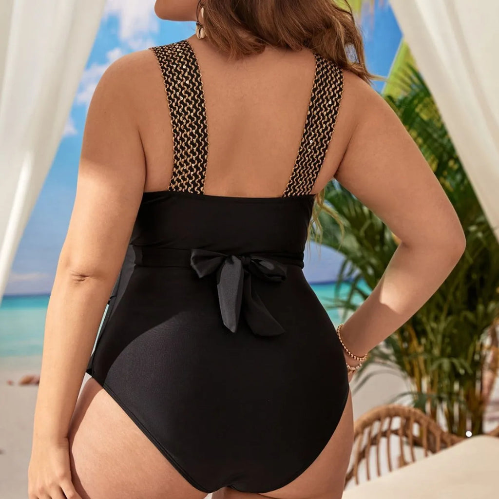 Women's plus-size black one-piece swimsuit with built-in chest pad, sleeveless design.