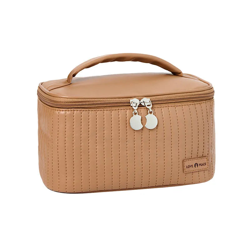Open-top cake shaped makeup bag in solid colour PU leather, shown in a light blue colour variant.