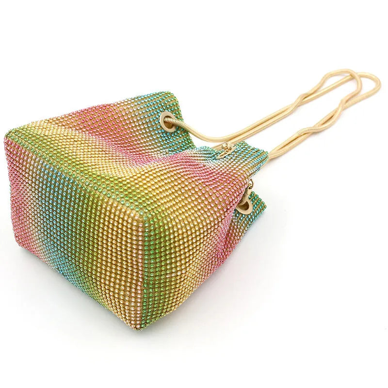 Small rainbow-coloured rhinestone bucket bag with a soft fabric construction.