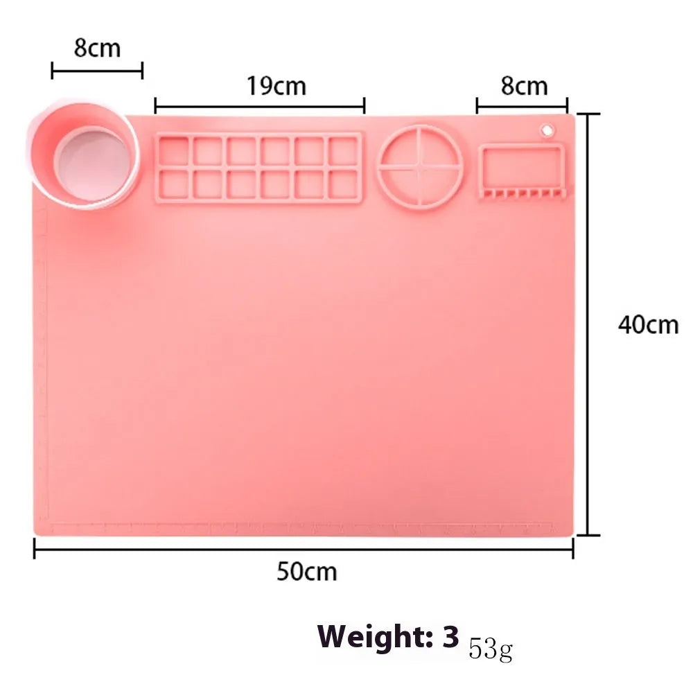 Green silicone painting mat measuring 50x40cm with two round paint mixing bowls on the surface.
