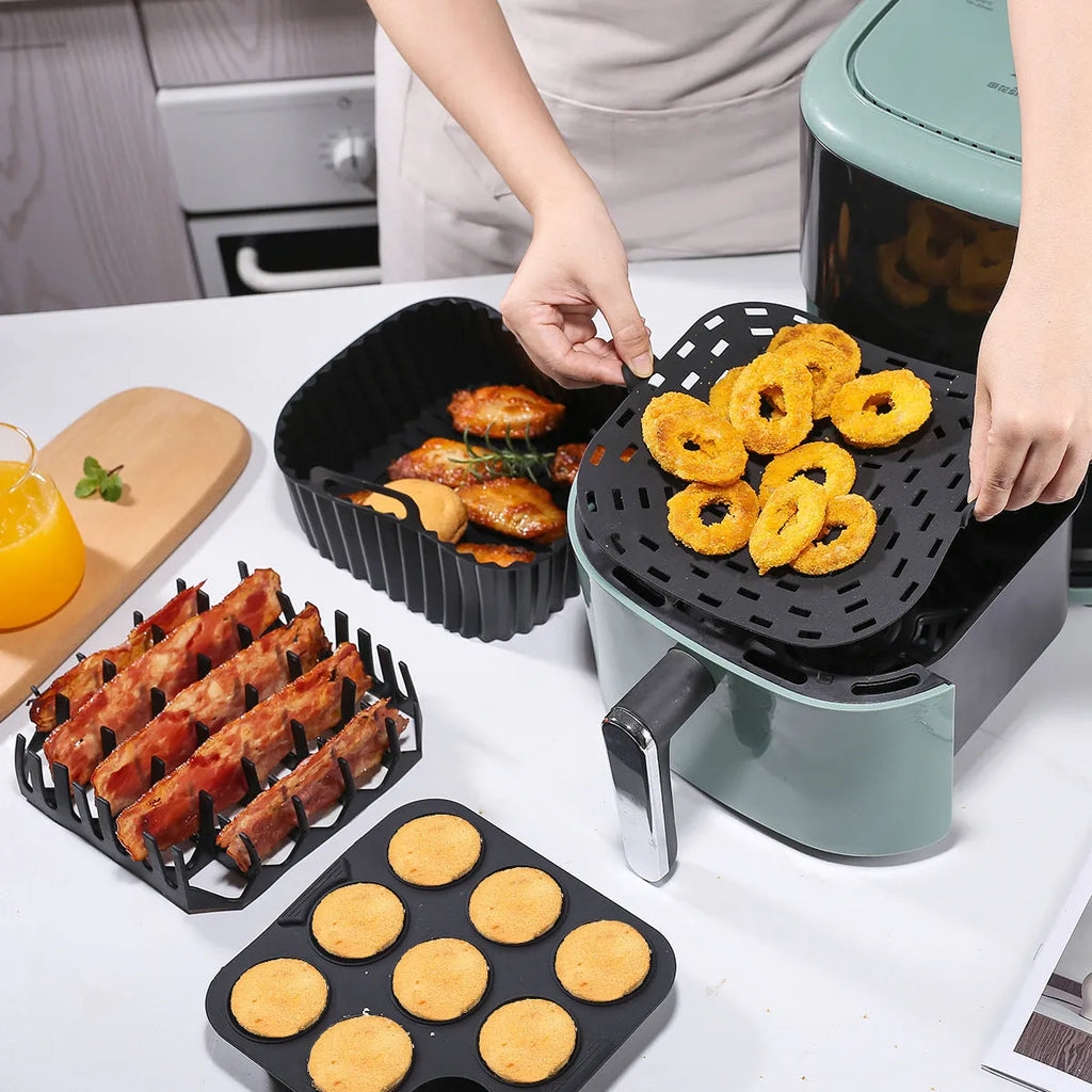 Black silicone baking tray set for air fryer including 4 square trays for cake, jelly, and pudding baking.