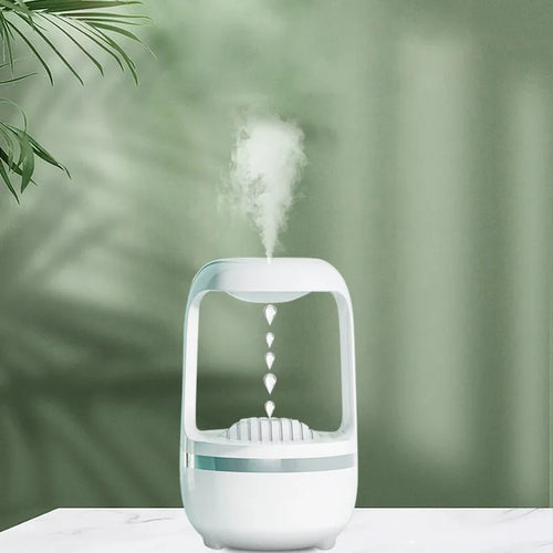 Black anti-gravity humidifier showing water droplet backflow effect with USB cable