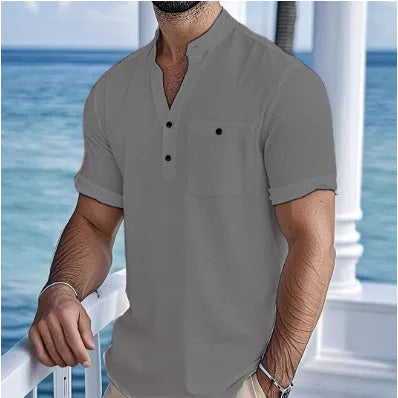 Man wearing a light-coloured linen stand collar short sleeve t-shirt in a relaxed fit.