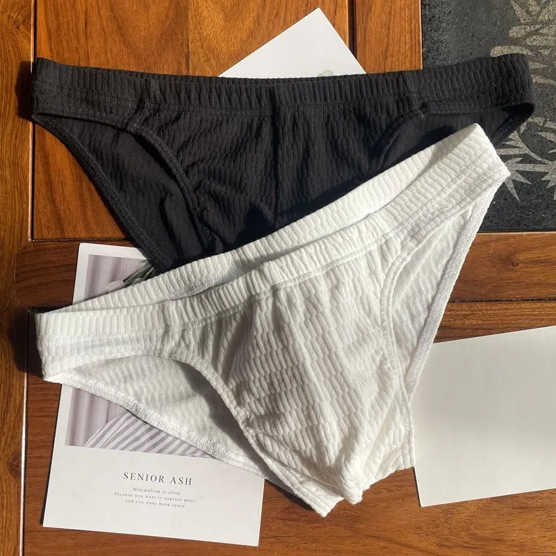 Men's solid colour cotton briefs with a mid waist and triangle design.