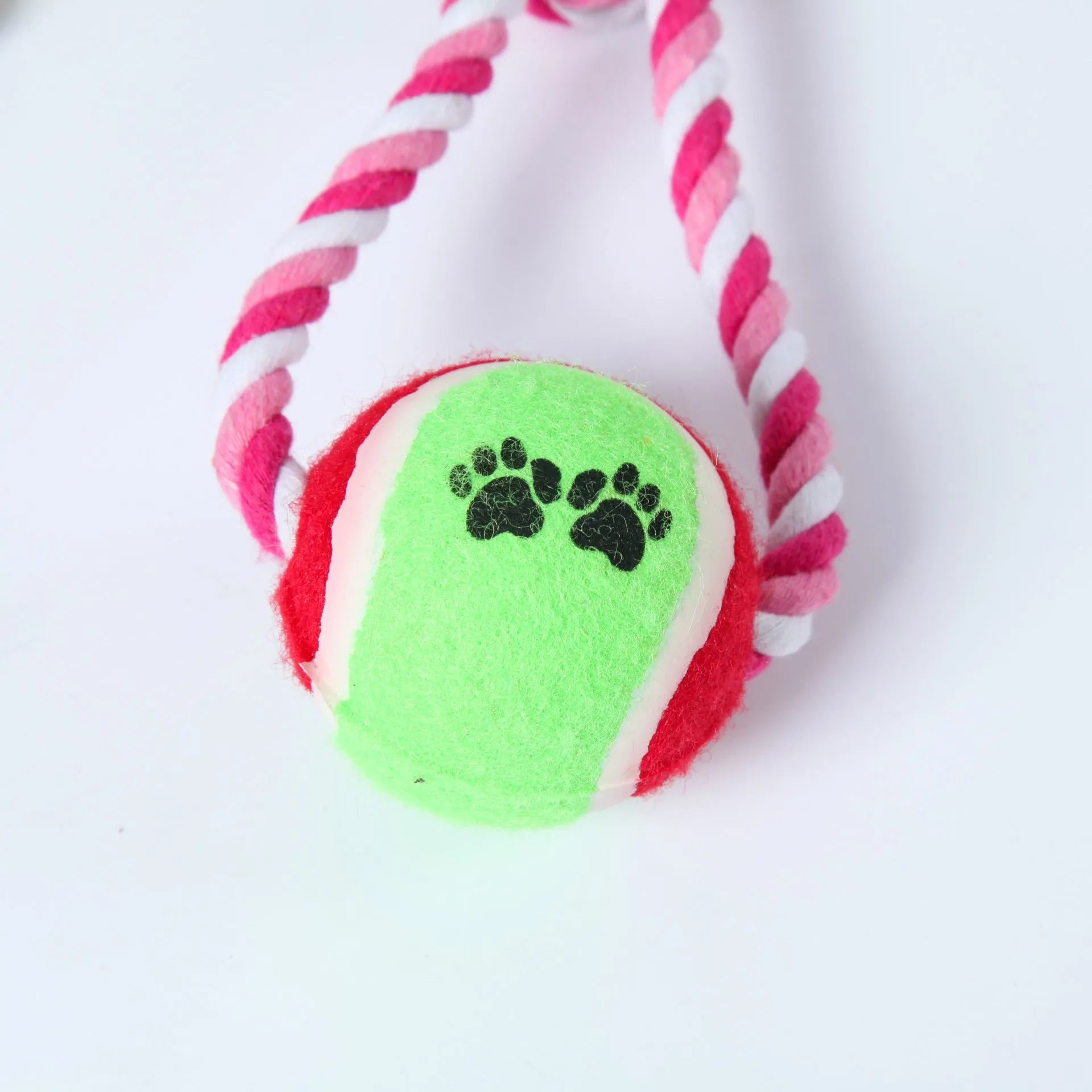 Braided red and white cotton rope dog tug toy for large breeds on a wooden floor.