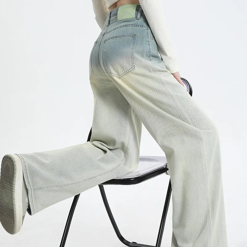 Women's gradient blue straight-leg denim trousers on a model, showing the ombré colour effect.