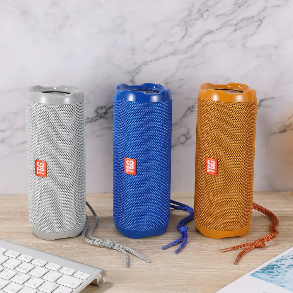 Fabric-covered portable Bluetooth speaker with integrated card holder in choice of colours.