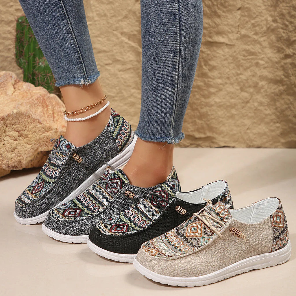 Women's black slip-on flat shoes with round toe and low-top profile on a neutral background.