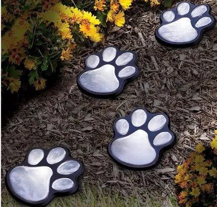 Black solar powered animal paw print LED garden lights set of four with solar panel pole