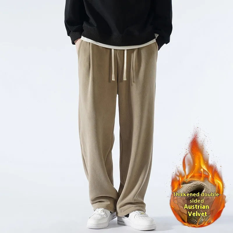Men's thick apricot coloured fleece-lined loose fit casual sports trousers on a hanger.