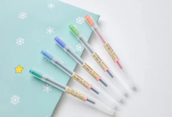 Muji 12-piece gel pen set with 0.5mm fine nibs showing blue ink demonstration